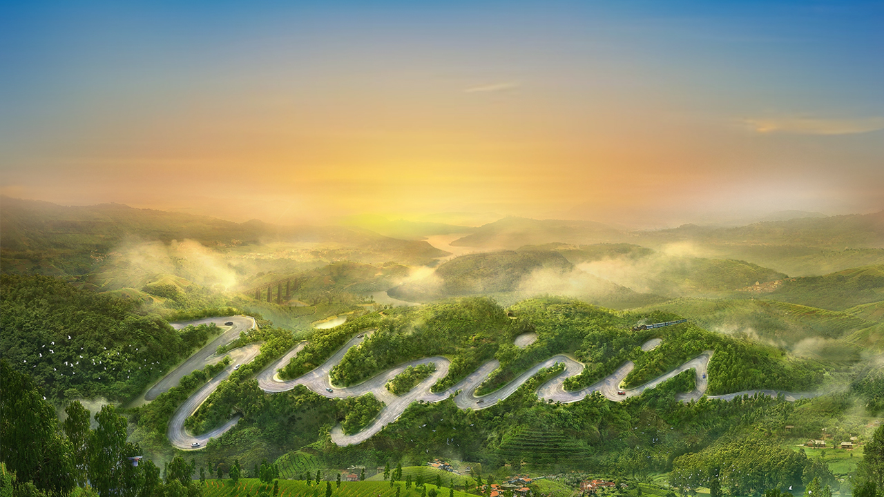 Sunrise over green hills and a winding mountain road